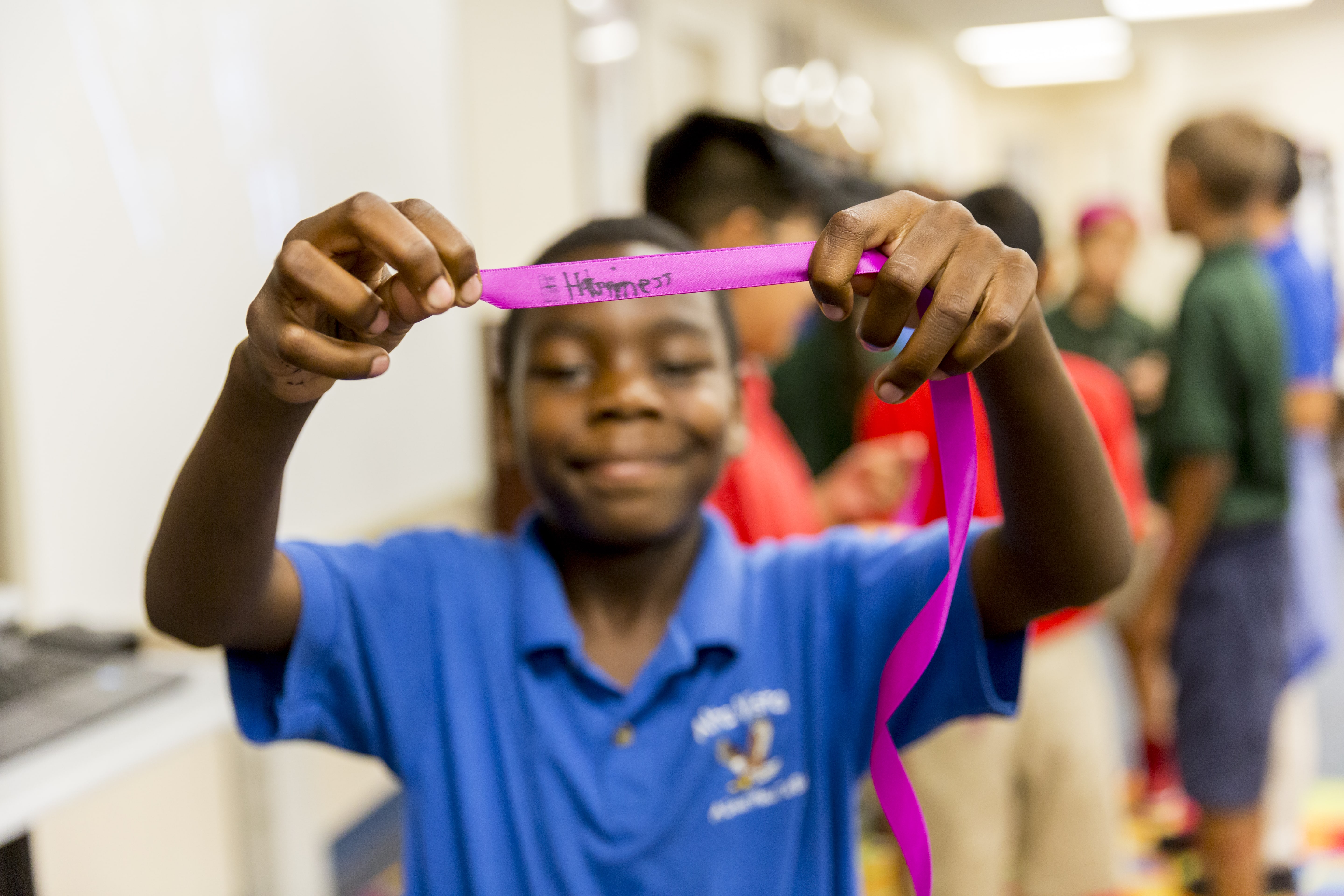 student-holding-up-ribbon.jpg